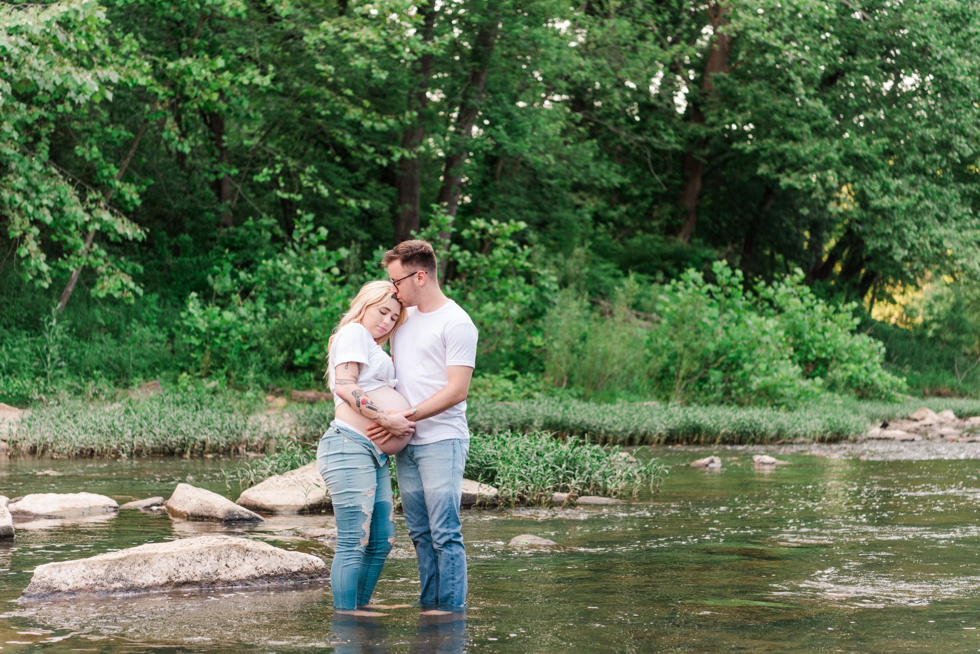 Casual maternity photos in jeans and white shirt in stream in Zelienople, Pennsylvania