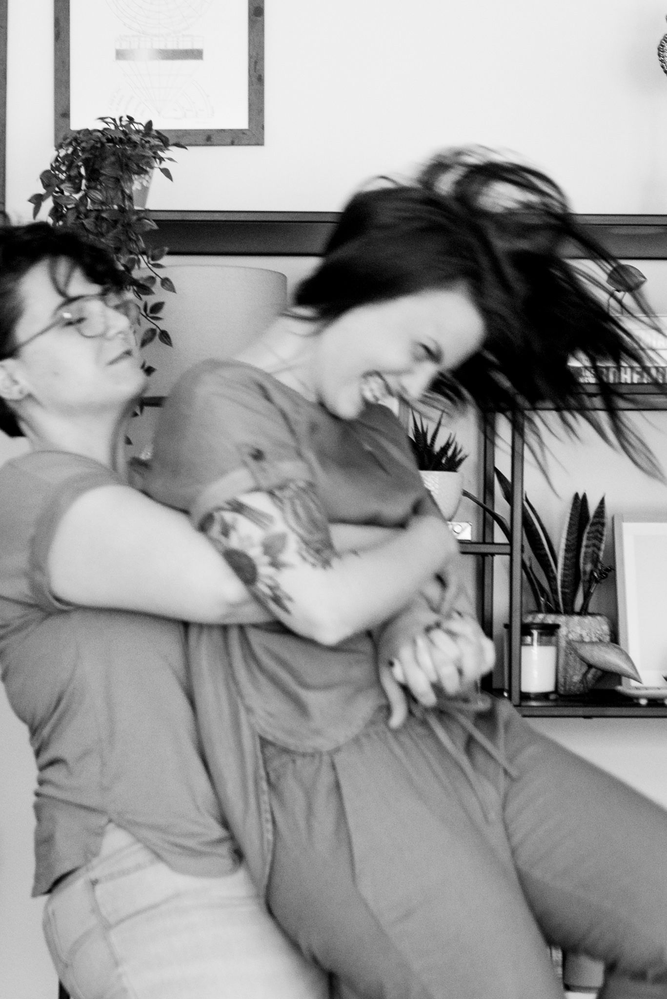 blurry black and white photo of woman spinning around other woman with hair flipping