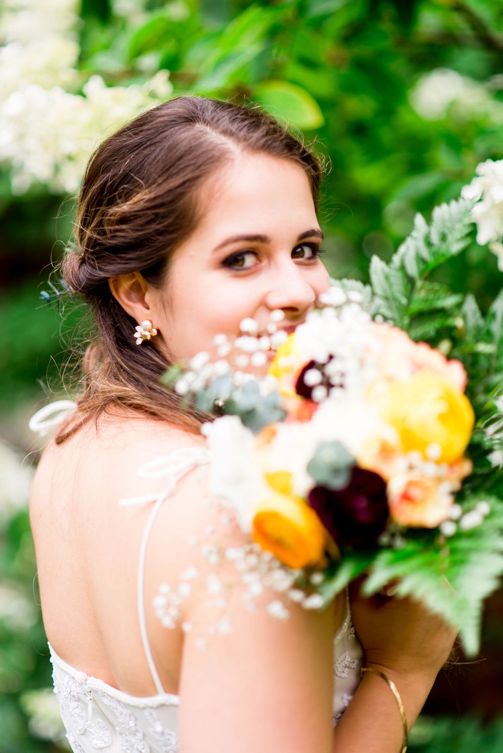 bride peeks through her fall diy wedding bouquet at Woman's Club of Evanston Garden Wedding in Chicago