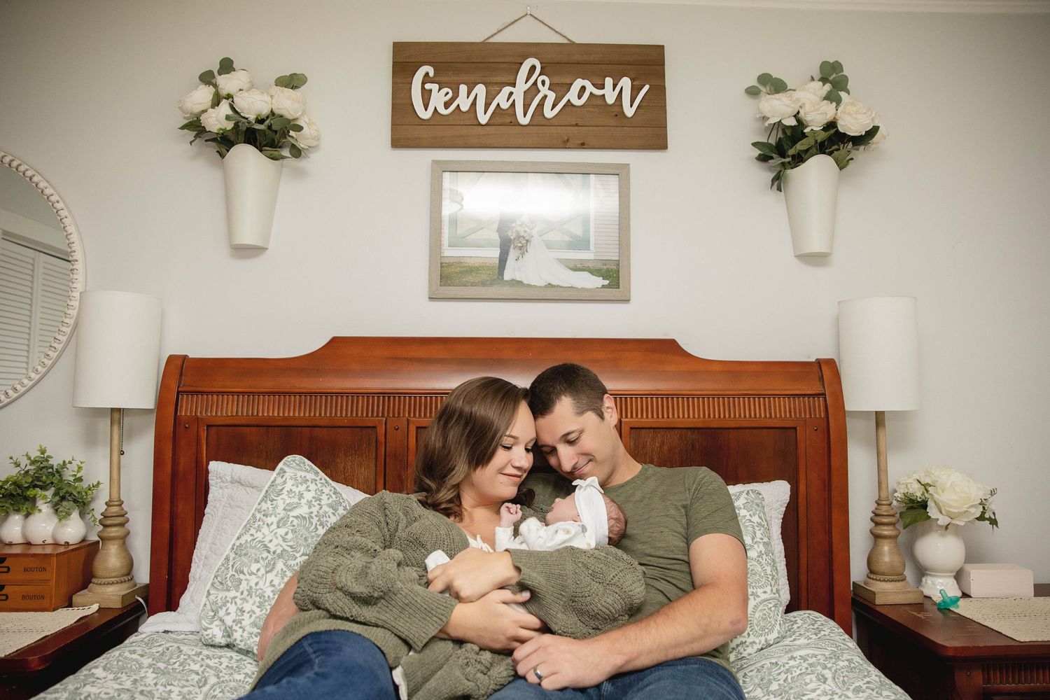 A cozy bedroom scene with rustic decor and floral accents above a wooden headboard.