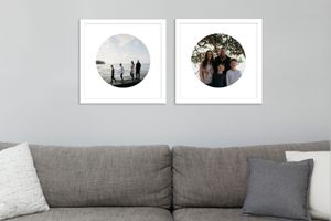 two circle framed images hanging above a couch