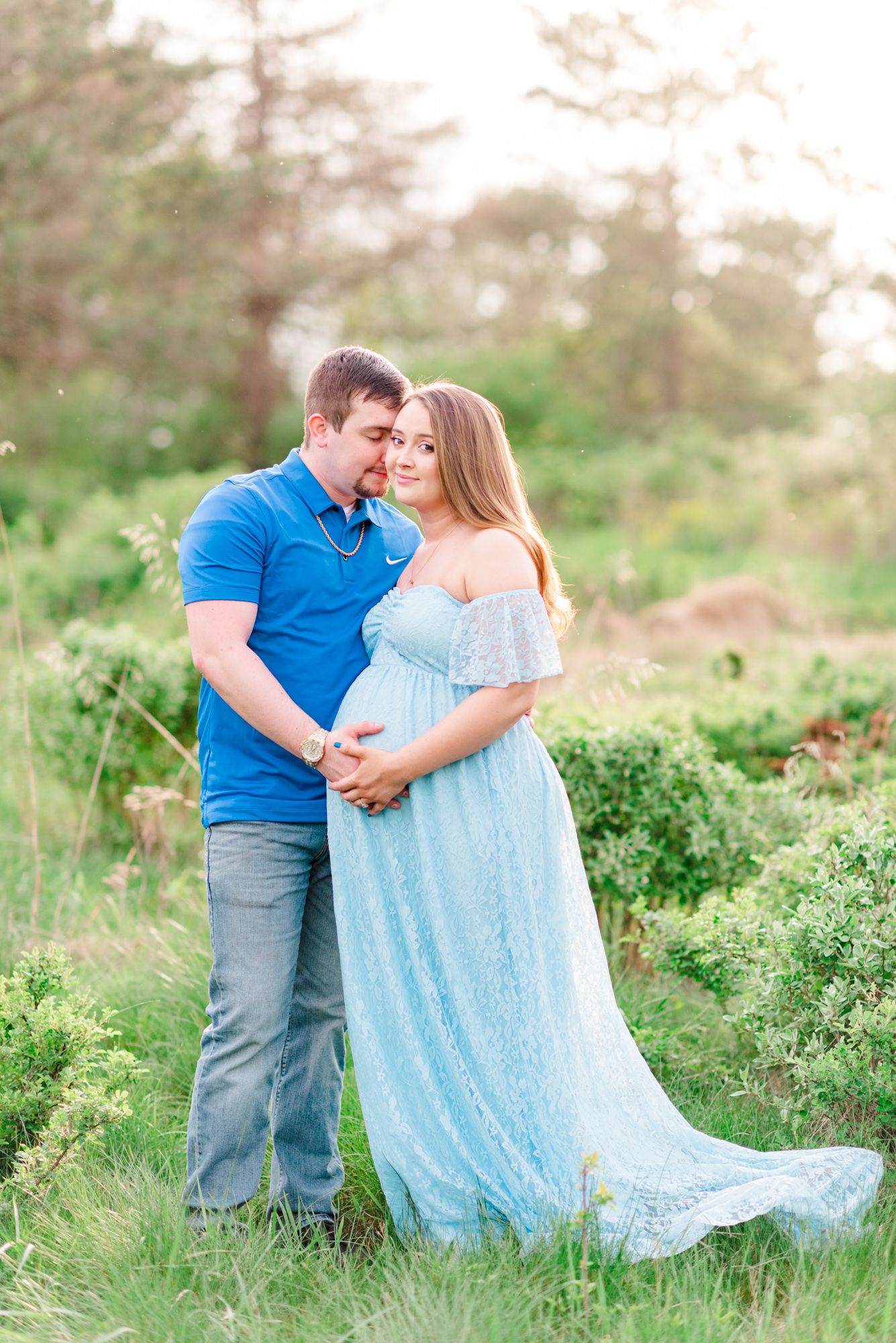 Maternity session with couple in field in golden hour sunlight at Moraine State Park, Pennsylvania