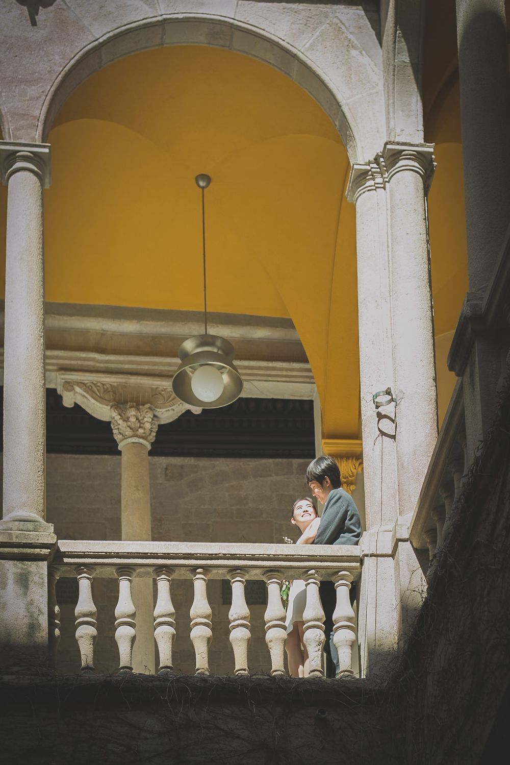 A couple cuddle after their recent engagement on the balcony