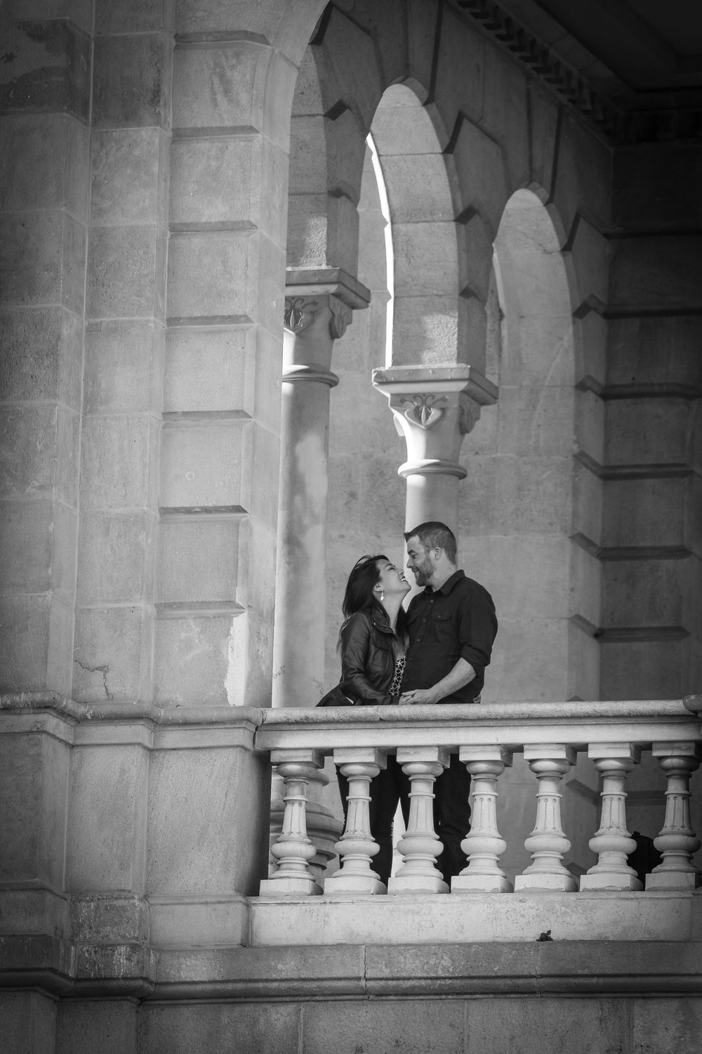 A couple gaze affectionately at each other in Parc Cuitadella after their engagement