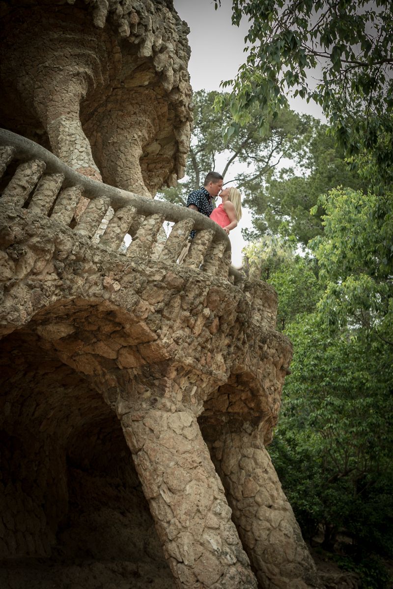 A man kisses his future wife after their engagement in Parc Guell