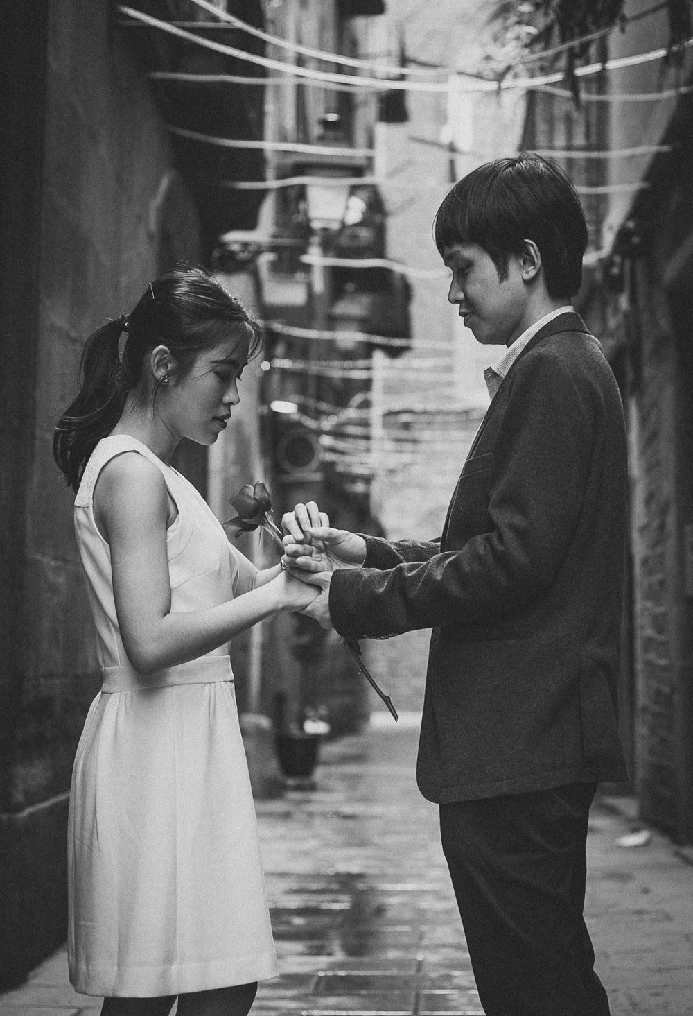 A man gives his woman a rose to symbolise their engagement in the historical streets of Barcelona