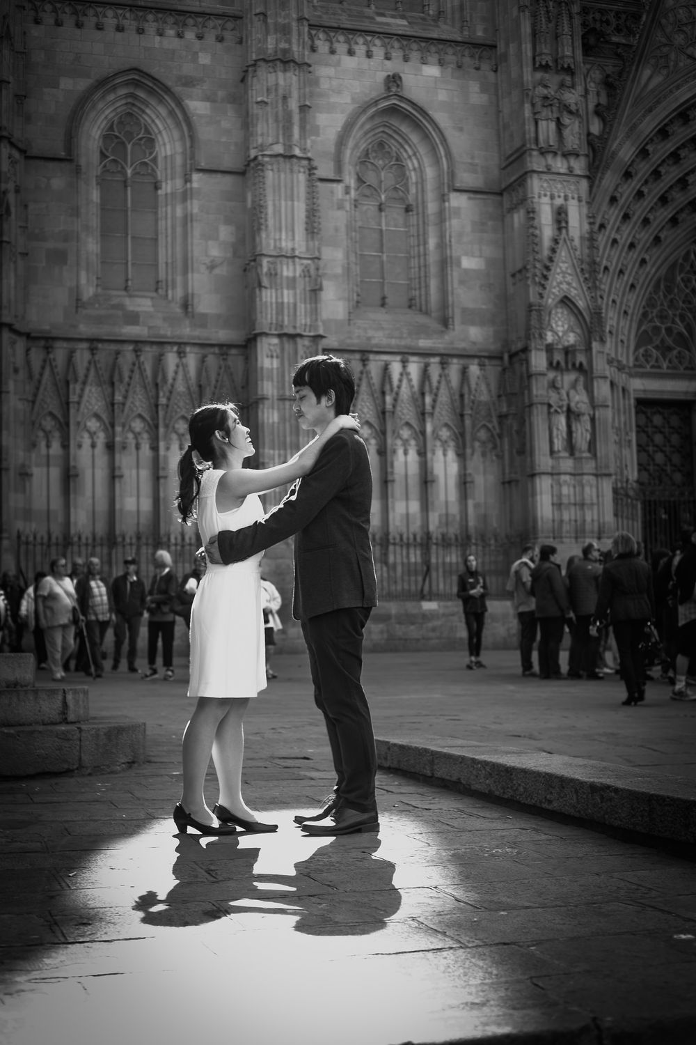 Couple dance romantically outside of the cathedral making a beautiful shadow