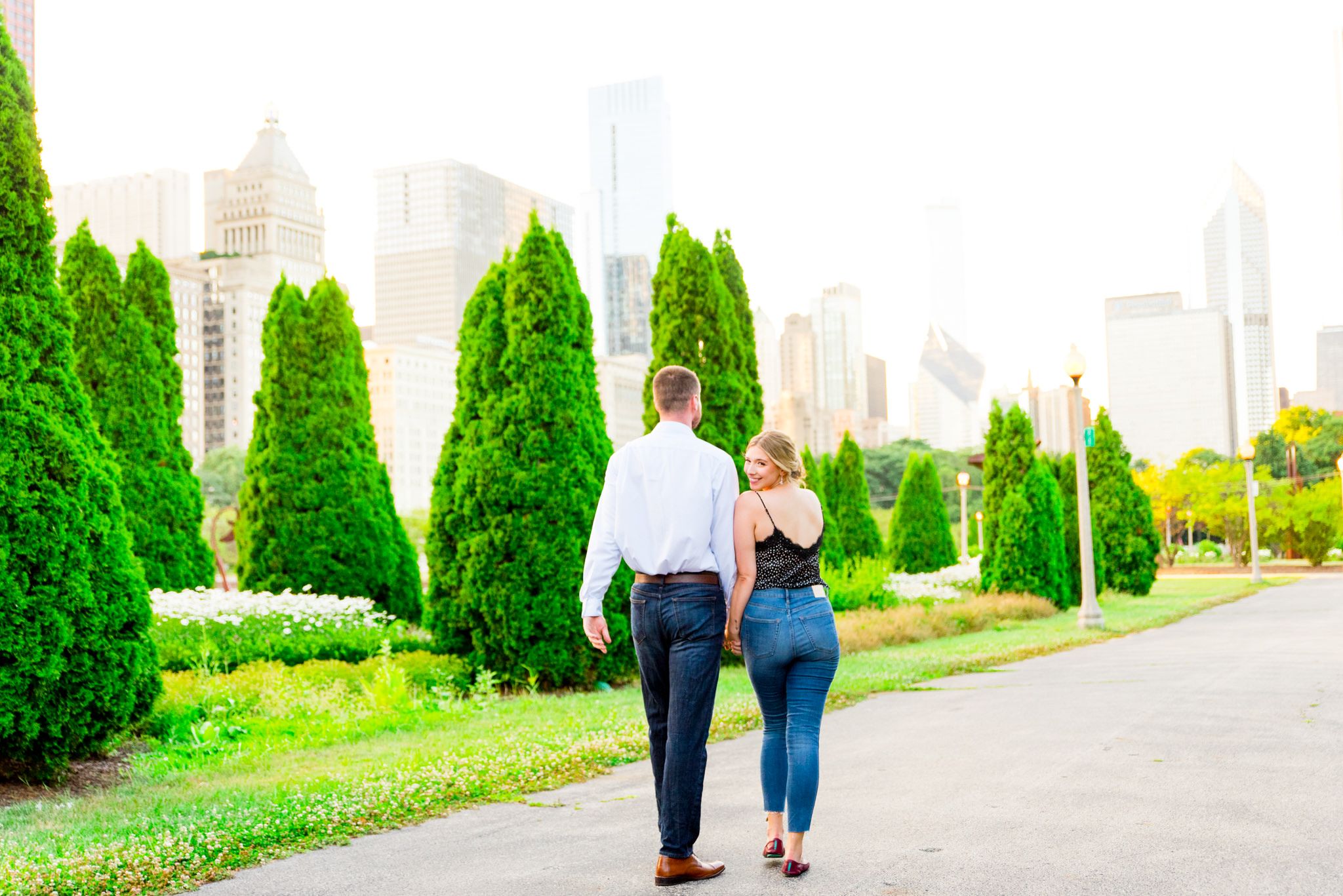man and woman walking towards Chicago through Grant Park