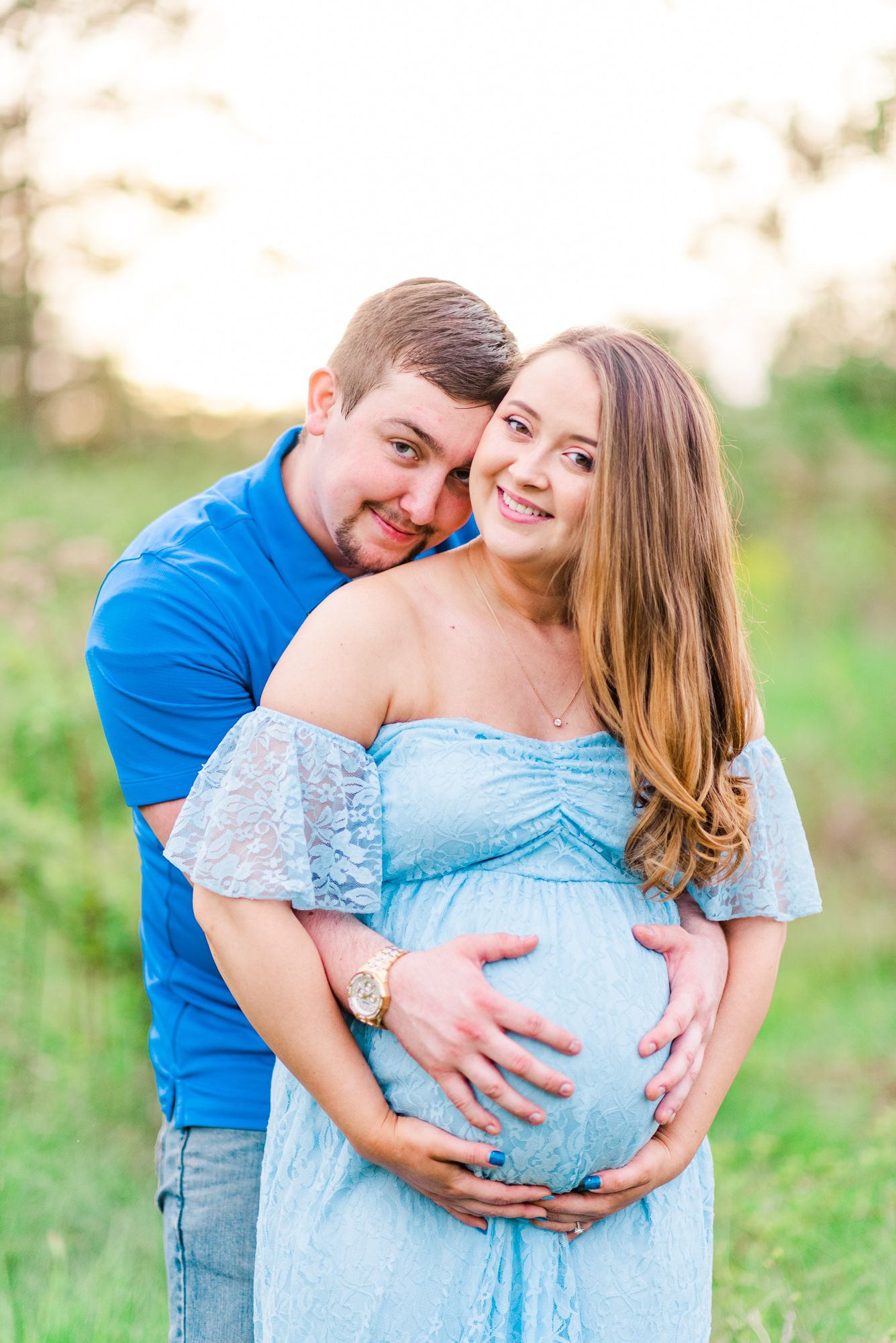 Maternity session with couple in field in golden hour sunlight at Moraine State Park, Pennsylvania