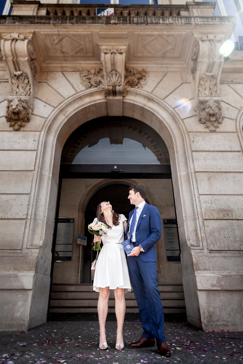 Couple sharing a moment under an ornate stone archway entrance with decorative carvings.