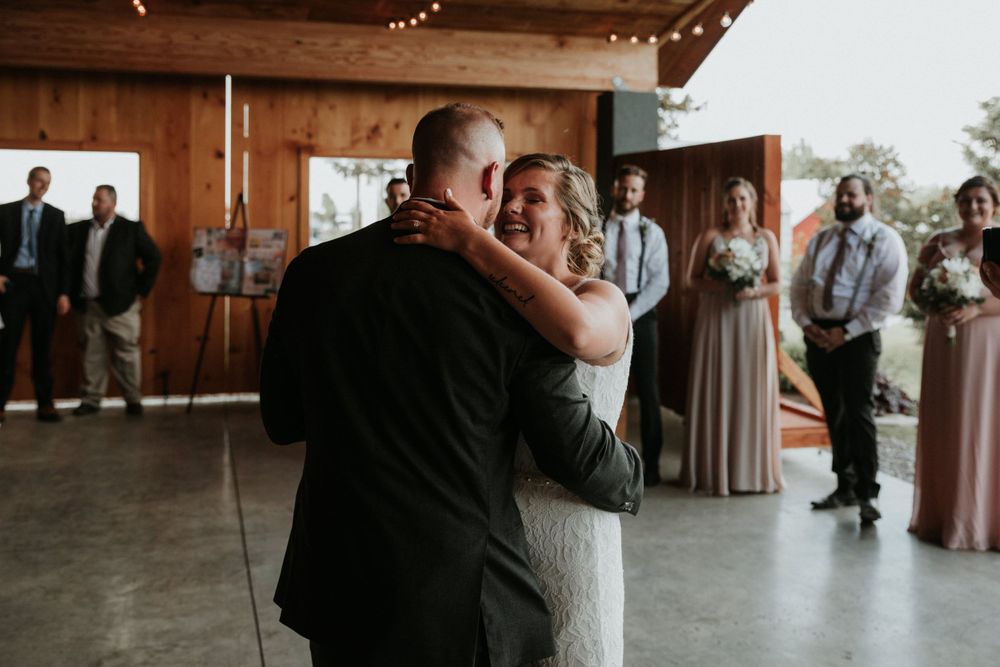 bride giggling at groom during first dance