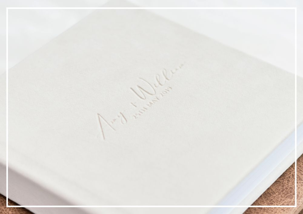 Luxury Heirloom Albums offered by Faye Amare Photography photo shows ivory suede album