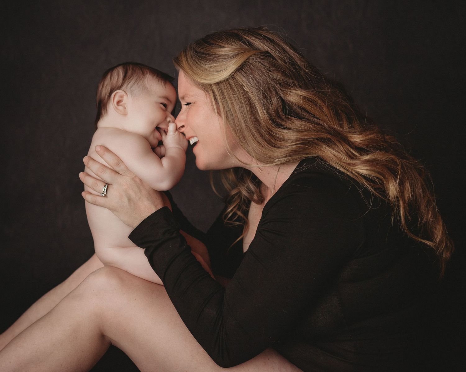 mom and baby girl laughing mom and daughter black bodysuit studio photography nose to nose posing