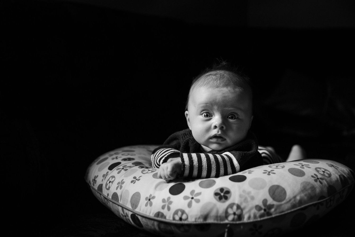 three month old baby girl on cushion