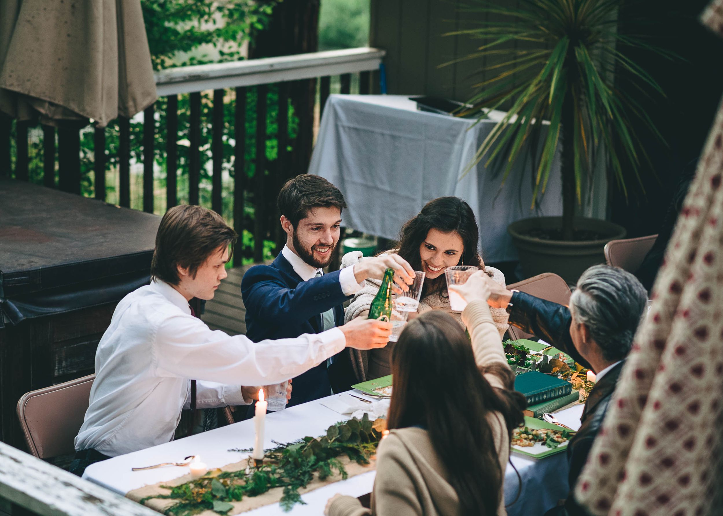 toasting glasses together at intimate wedding reception