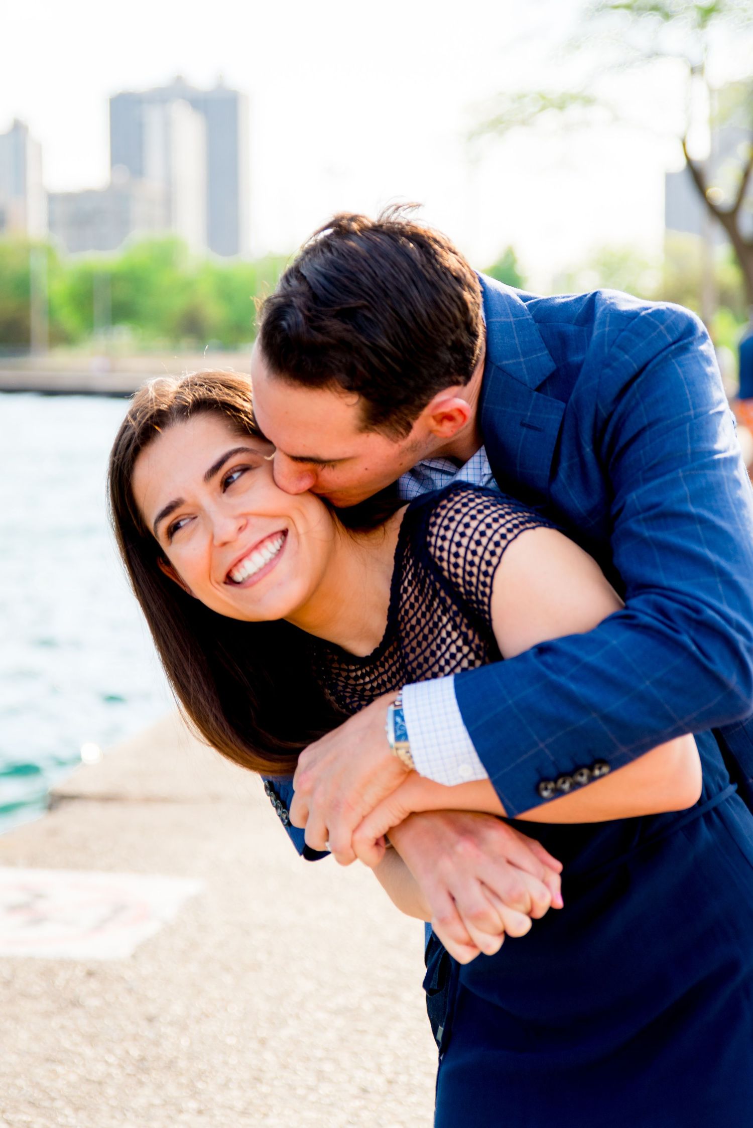 man and woman kissing in front of Hancock tower after North Avenue Beach proposal