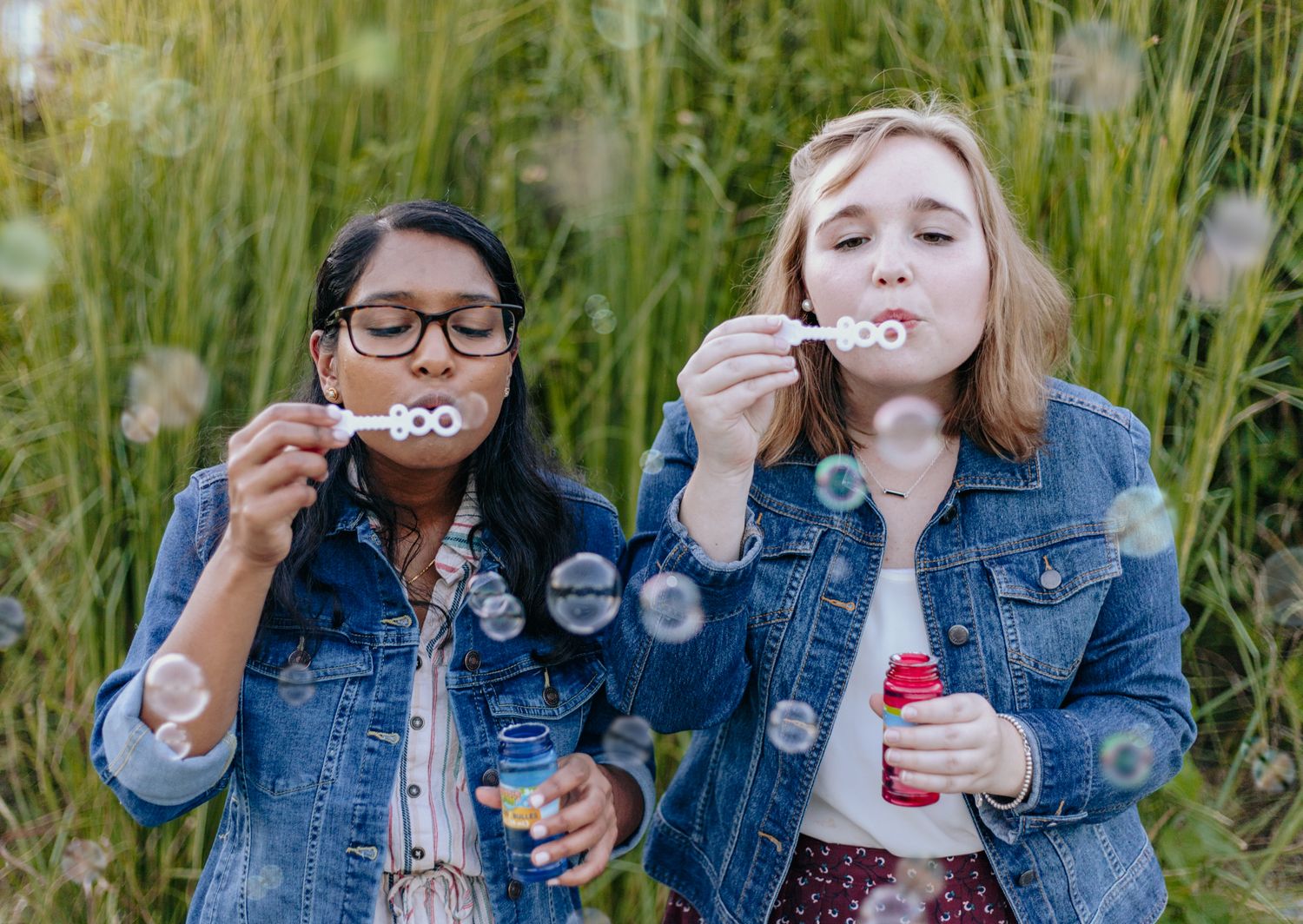 Two best friends blow bubbles with each other