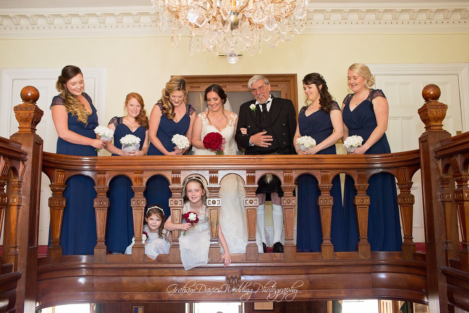 fun wedding party photo on stairs at Court Colman hotel