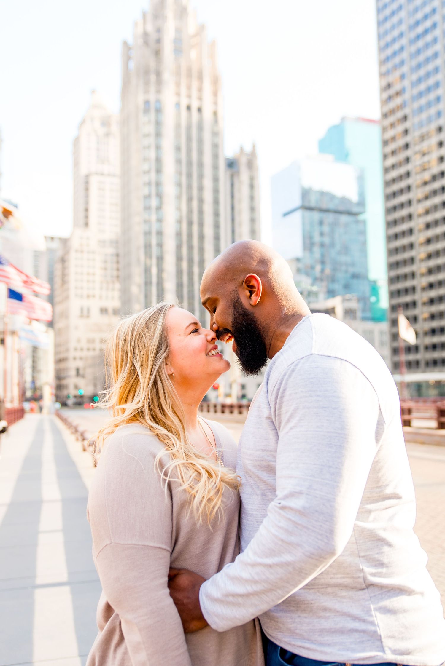 man and woman laughing in Chicago engagement photos in downtown Chicago near Wrigley Building