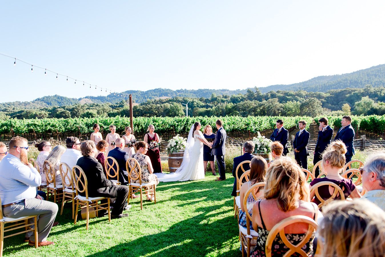 bride and groom hold hands in front of guests for outdoor wedding at Pennyroyal Farm in NorCal