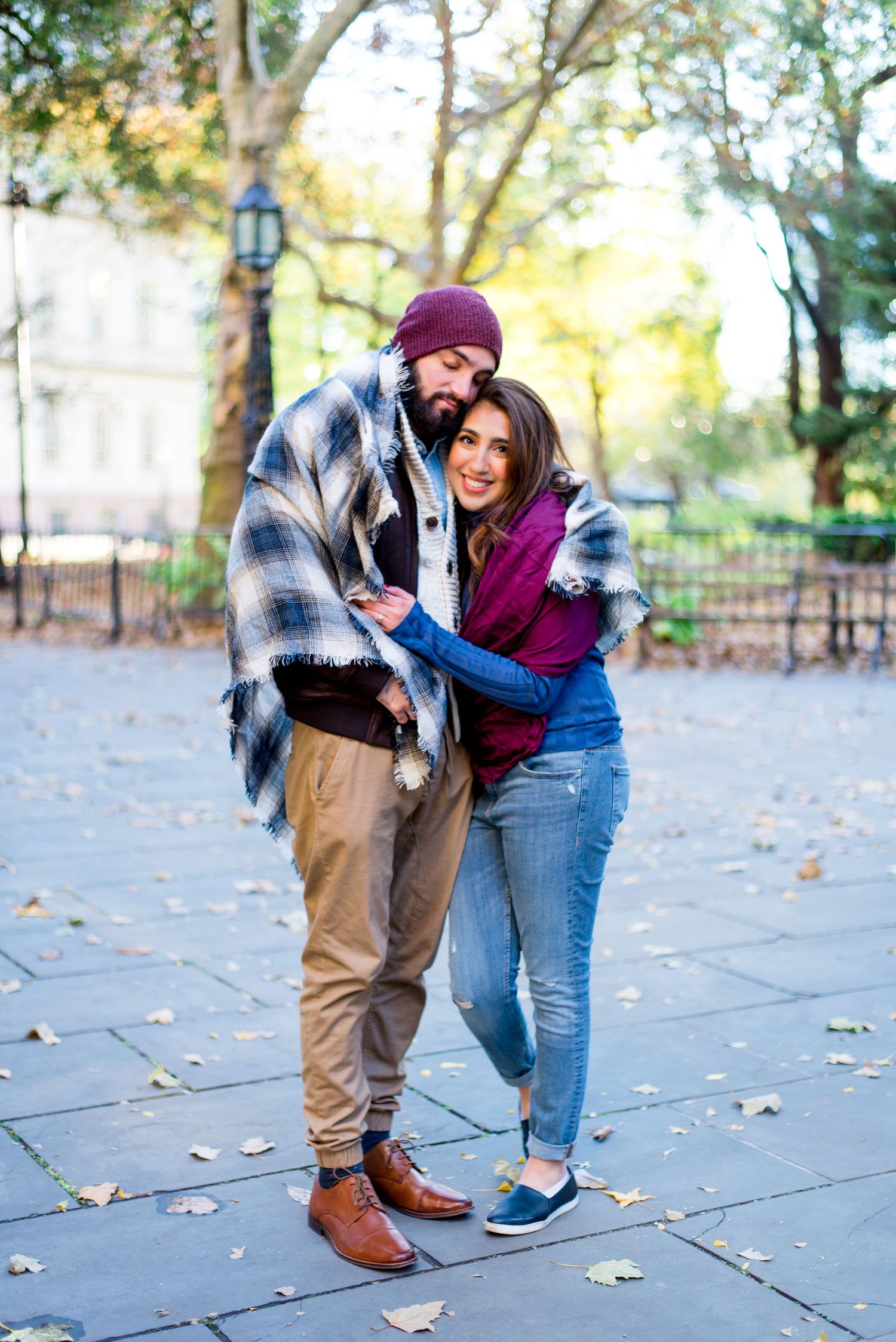 engaged woman hugs her fiance and smiles for November engagement pictures in New York City