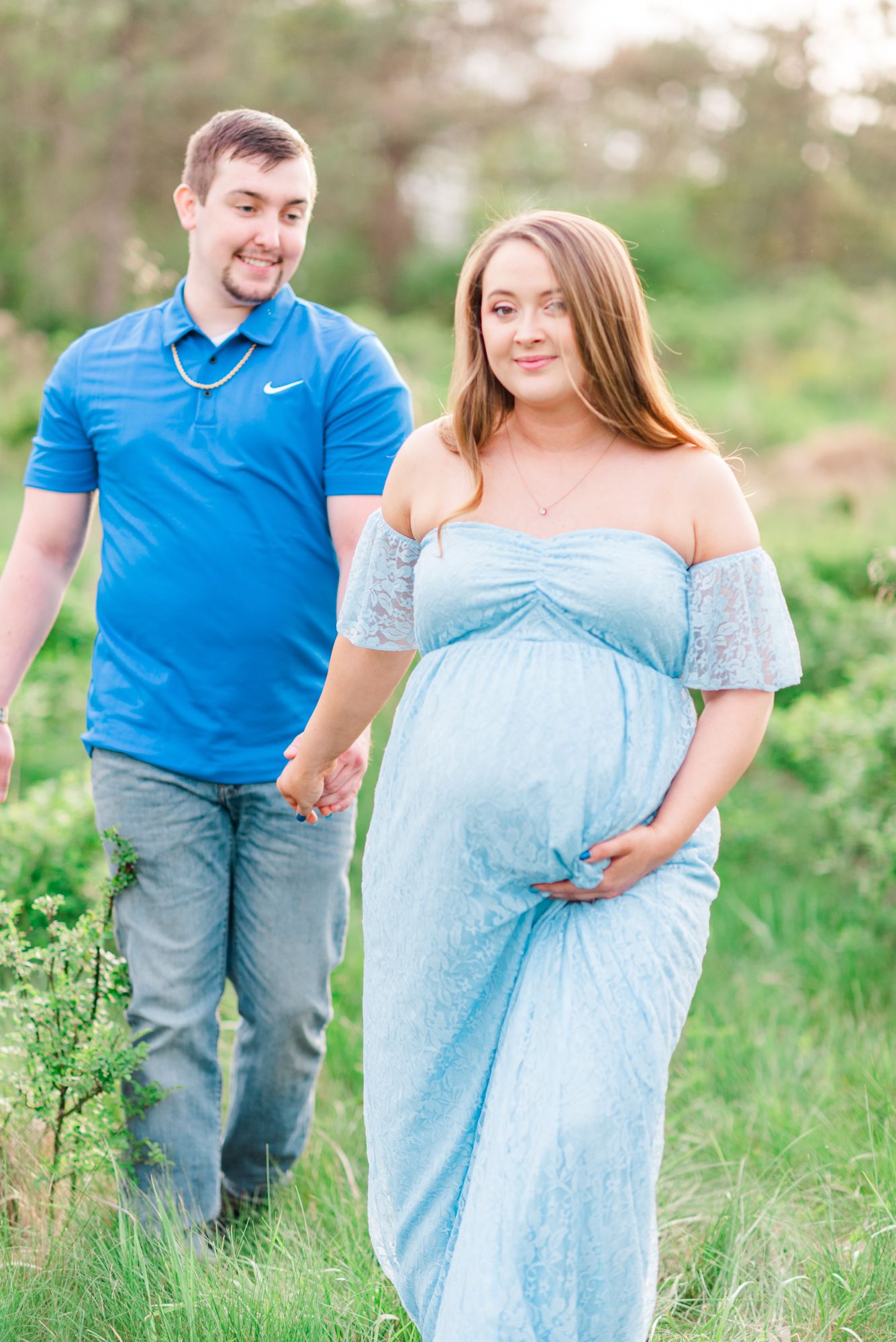 Maternity session with couple in field in golden hour sunlight at Moraine State Park, Pennsylvania