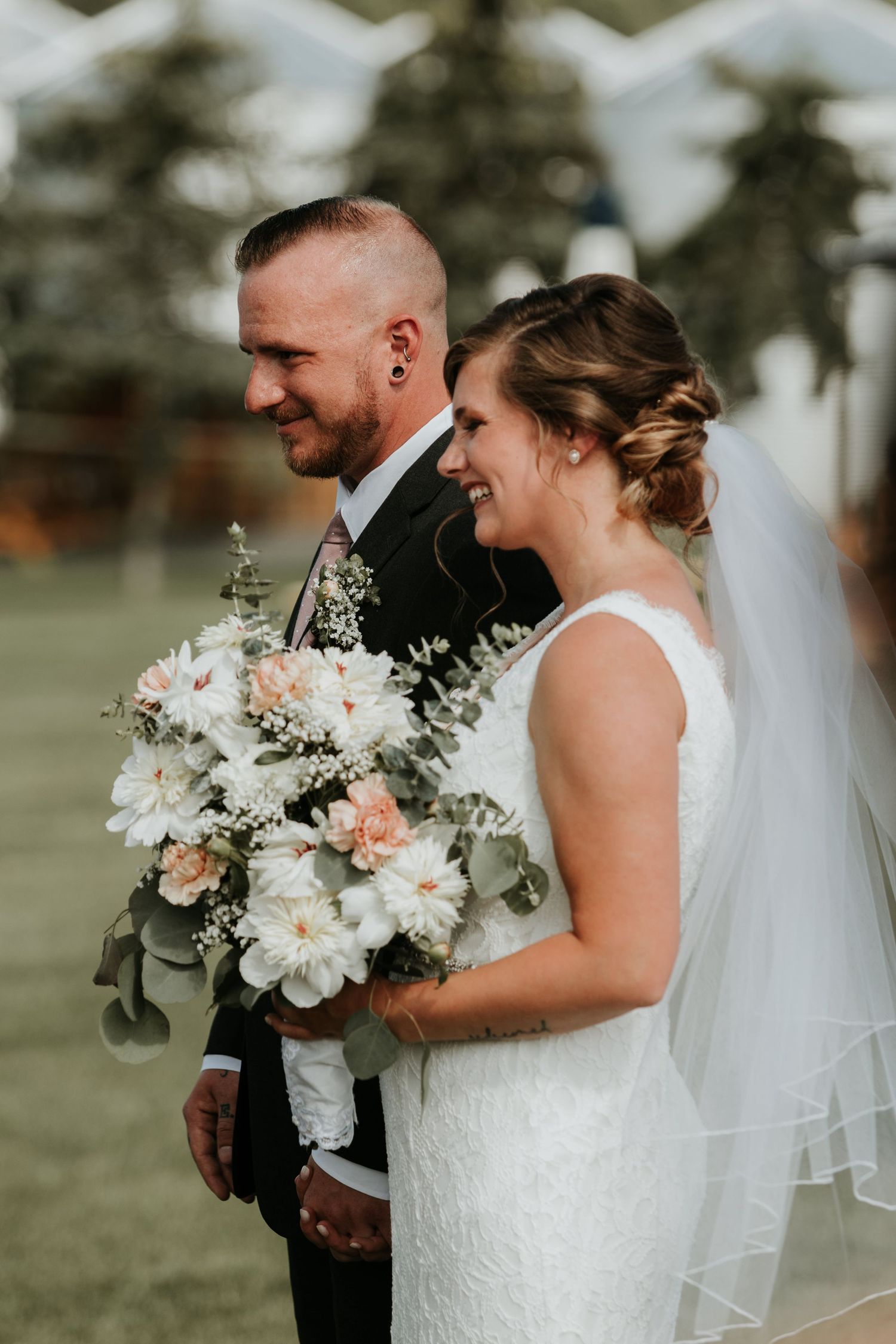 bride and groom standing at the alter