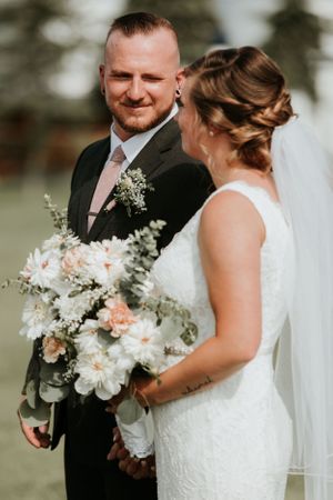 groom smiling at bride at the alter