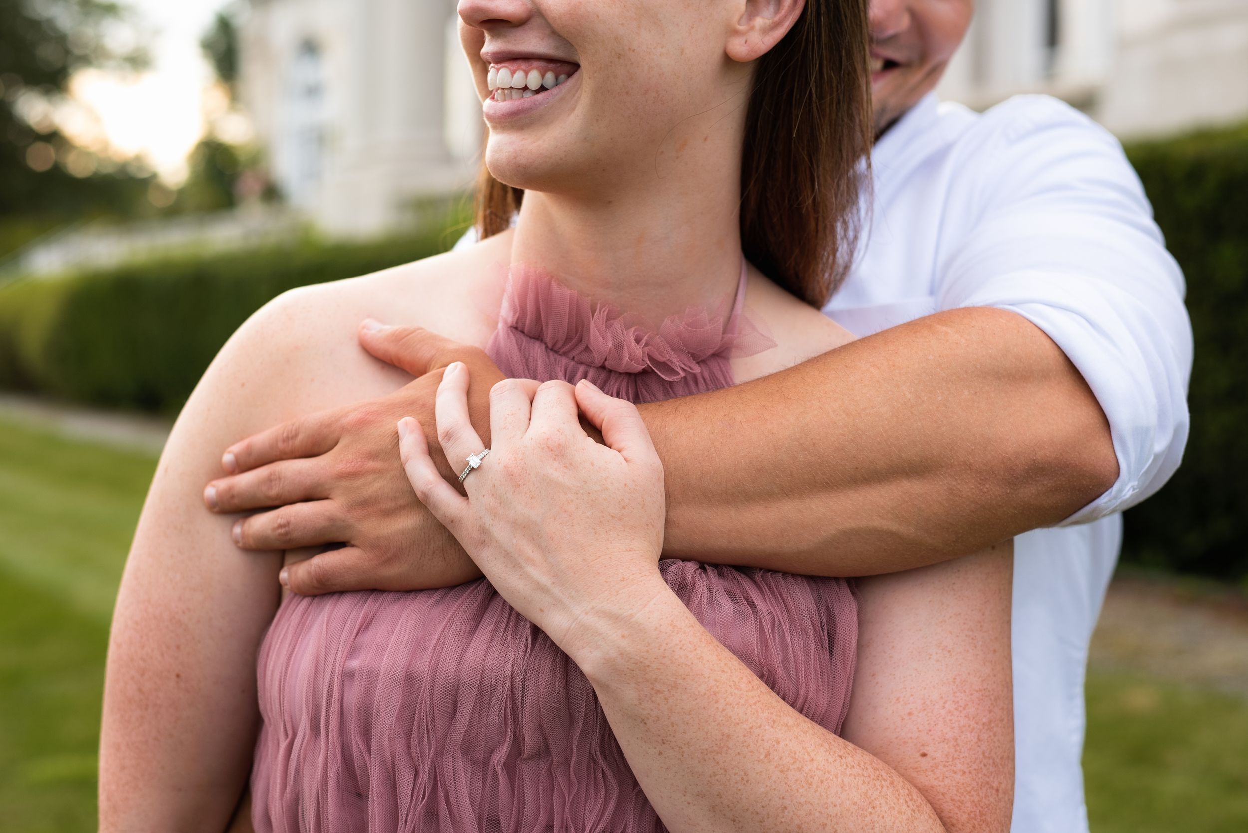 A close-up shot captures embracing hands and joyful smiles in an outdoor setting.