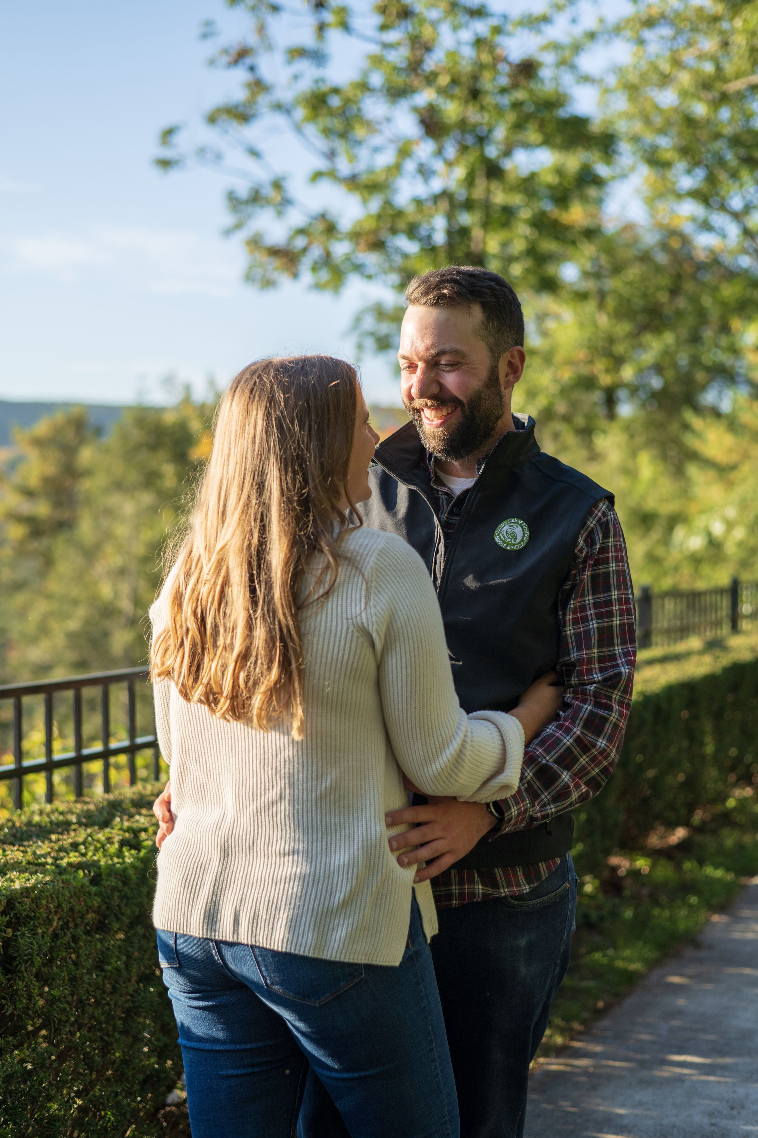 A romantic autumn moment captured on a scenic overlook with fall foliage in the background.