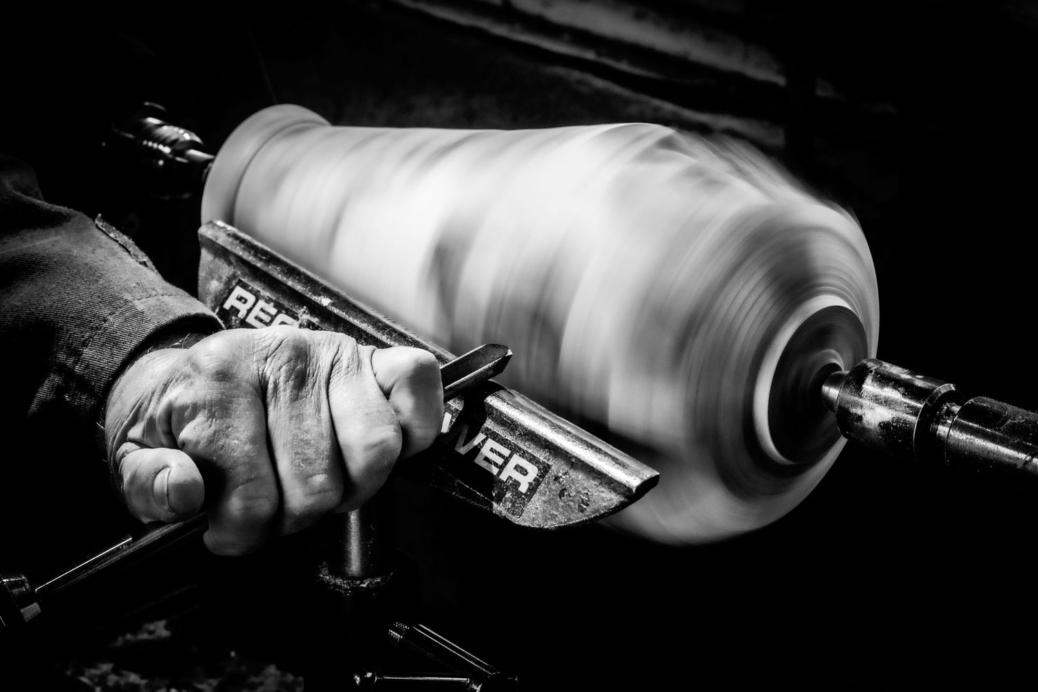 Talented wood turner crafting a beautiful wooden vase on a lathe