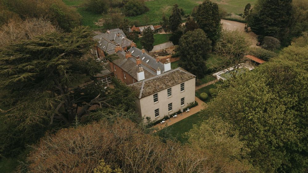 Aerial view of a Aswarby Rectory and traditional outbuildings nestled in lush countryside - taken by Grimsby photographers.