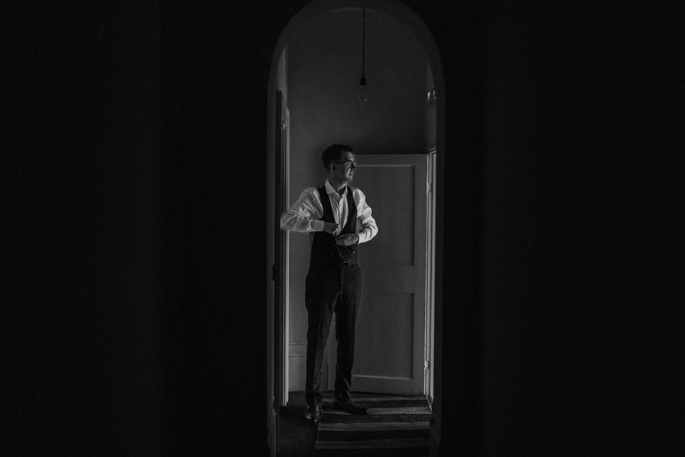 A groom stood in an archway at Aswarby Rectory - taken by Grimsby photographers.