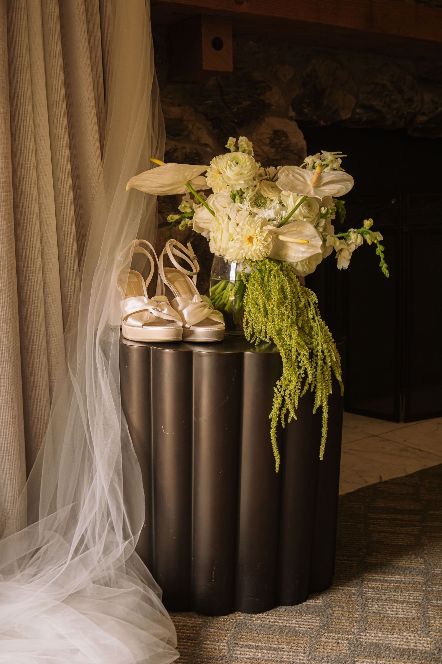 Colorado Springs Wedding Photographer. Photo of a stool holding decor and the bride's flowers and shoes.