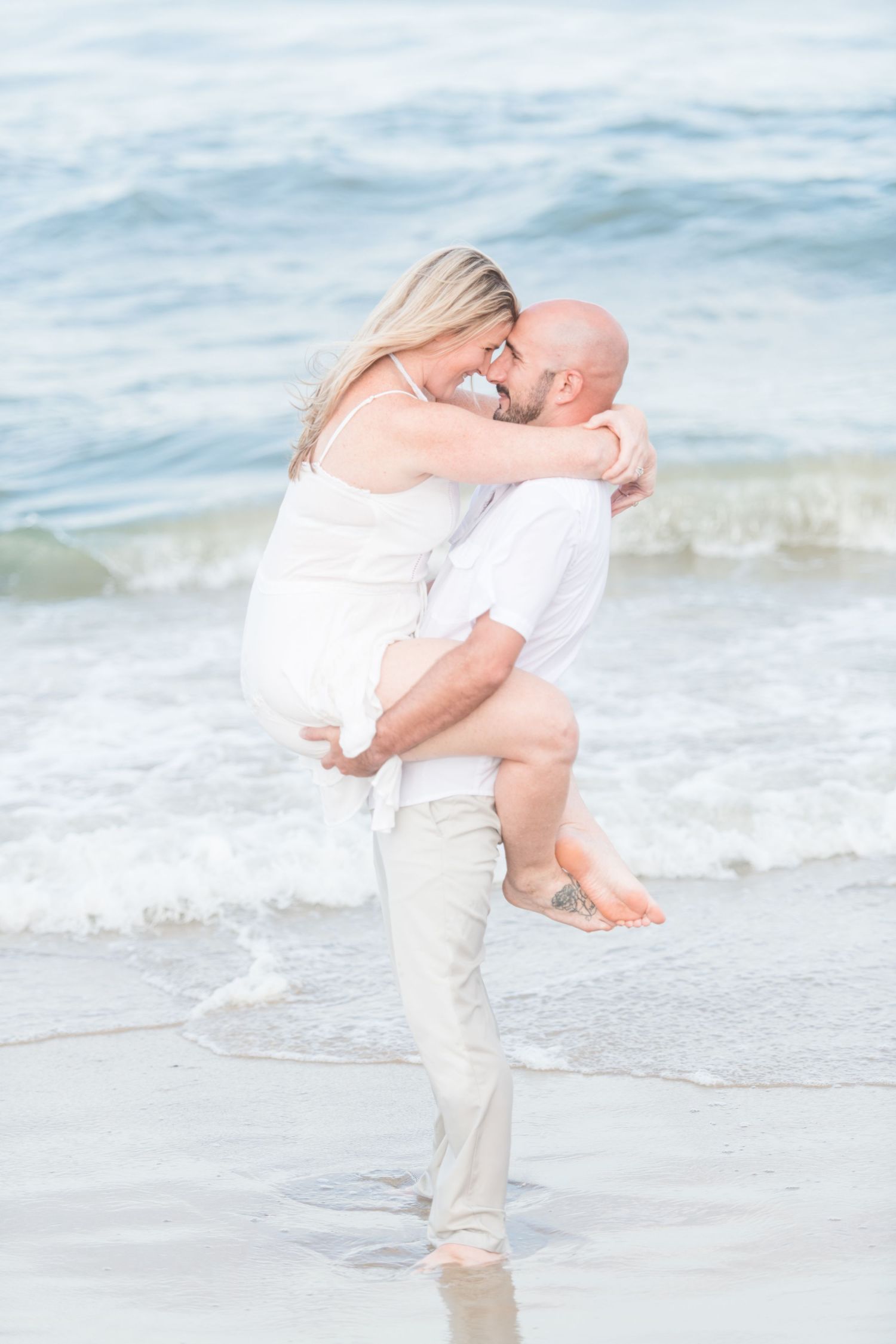 A couple embracing on Virginia Beach. Virginia Beach Photography. Beach Photoshoot.