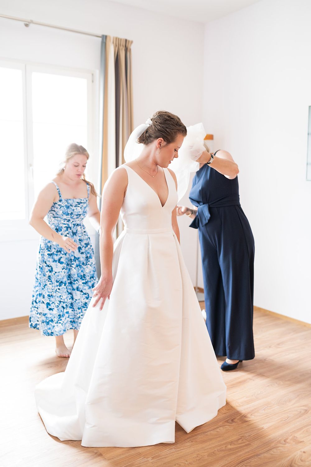 Bride getting ready at a hotel in Bad Ragaz, Switzerland - peaceful morning light, elegant details, and joyful anticipation with her friends