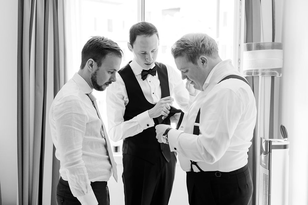 Groom getting ready at a hotel in Bad Ragaz, Switzerland - peaceful morning light, elegant details, and joyful anticipation with his friends