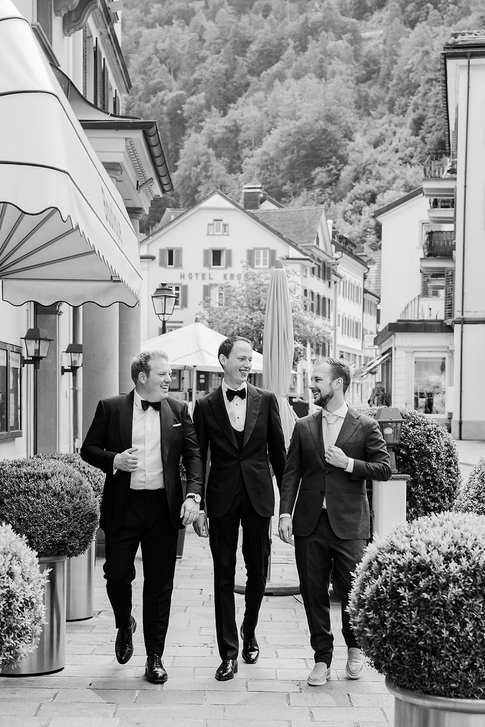 Groom getting ready at a hotel in Bad Ragaz, Switzerland - peaceful morning light, elegant details, and joyful anticipation with his friends