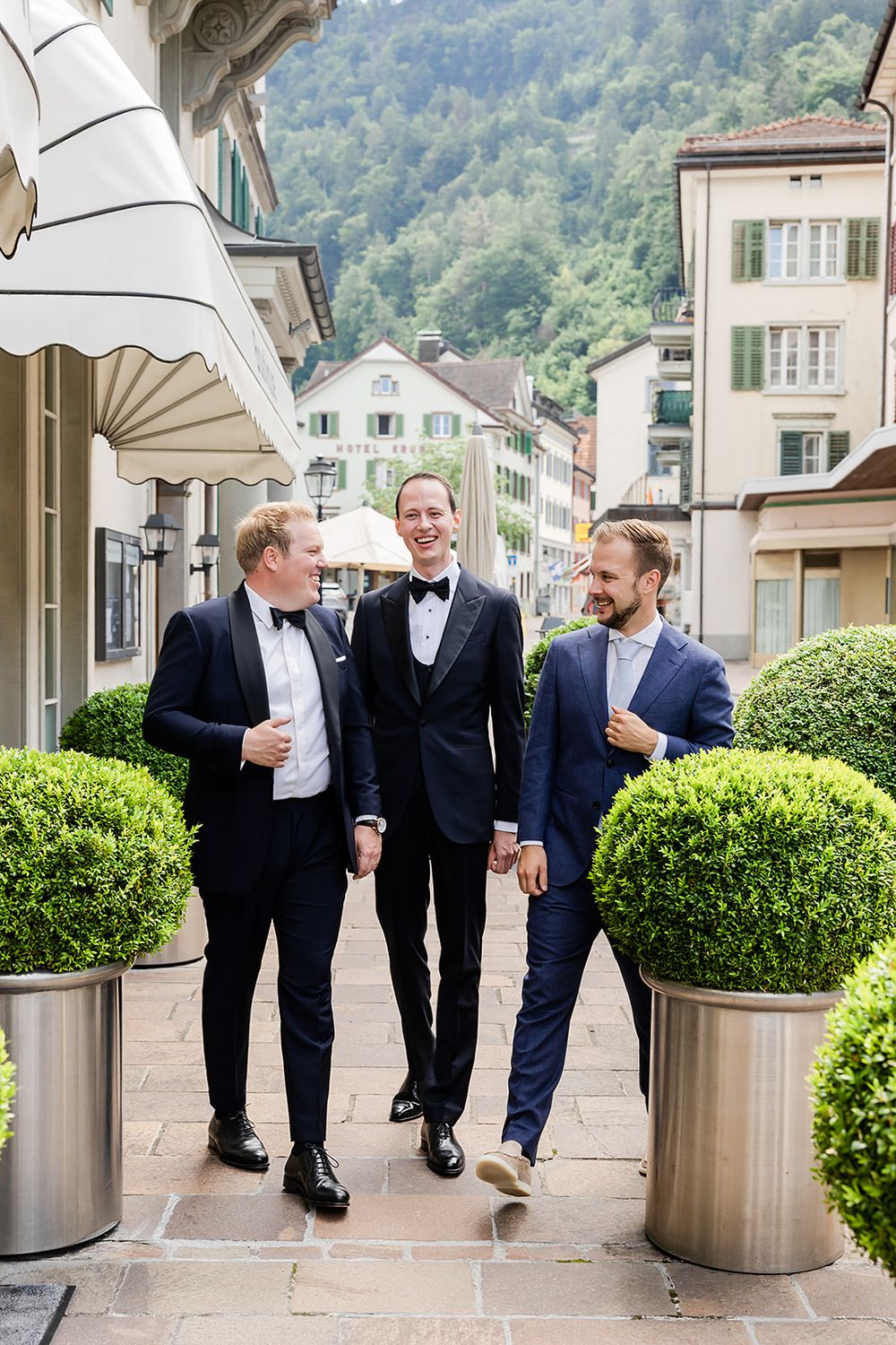 Groom getting ready at a hotel in Bad Ragaz, Switzerland - peaceful morning light, elegant details, and joyful anticipation with his friends