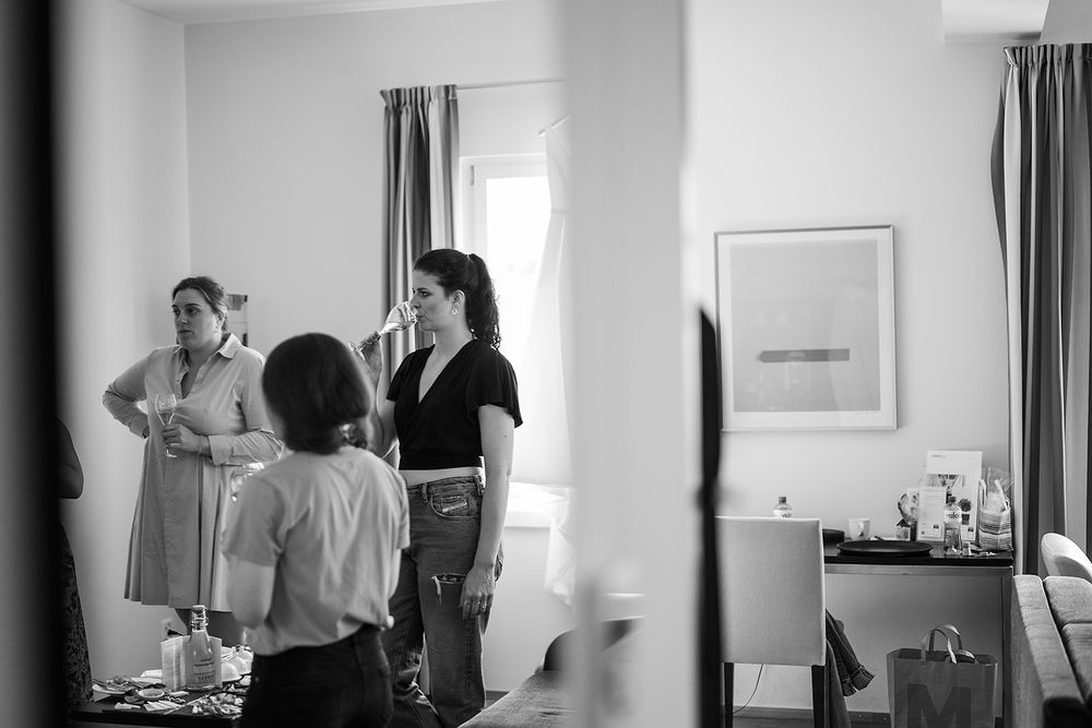 Bride getting ready at a hotel in Bad Ragaz, Switzerland - peaceful morning light, elegant details, and joyful anticipation with her friends