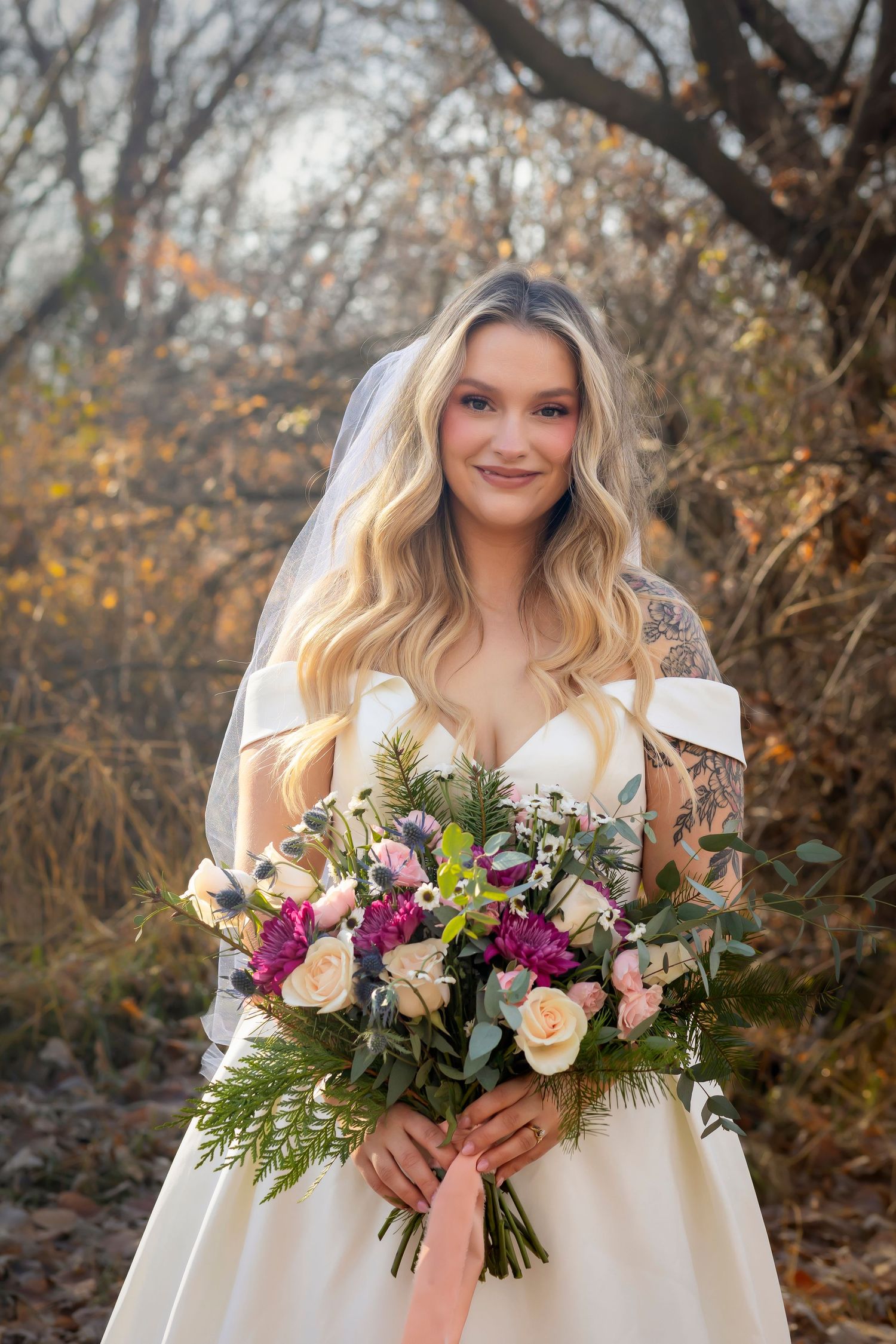 bride holding bouquet of white, dark pink, light pink and green
