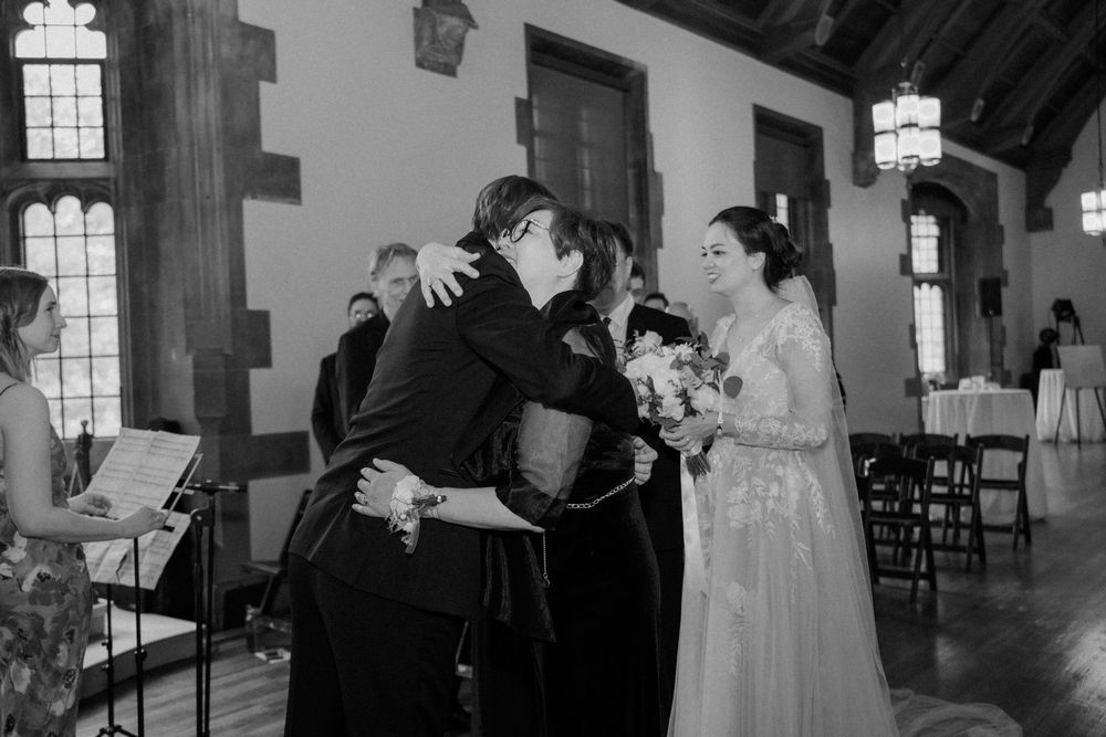 Black and white ceremony photos showing elegant wedding venue interior with vaulted ceilings.