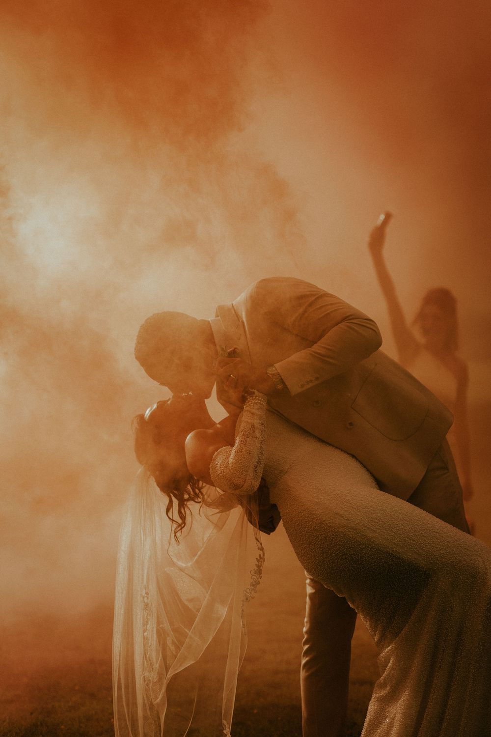 A romantic dance silhouette in golden haze with a dramatic dip pose captured at sunset.