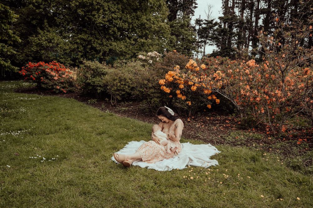 Mother breastfeeding baby in garden