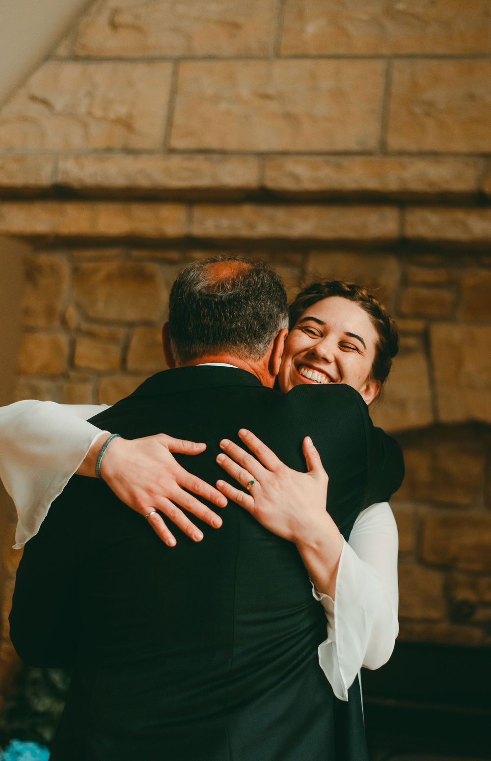Bride hugging dad when he first sees her in her wedding dress