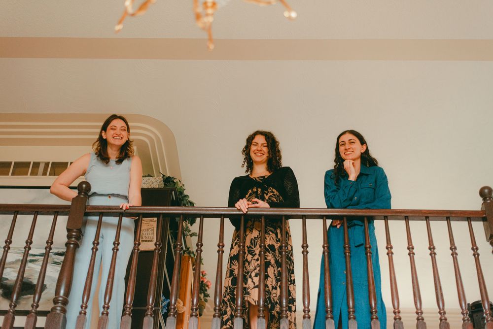 Friends overlook from balcony as a bride gets ready