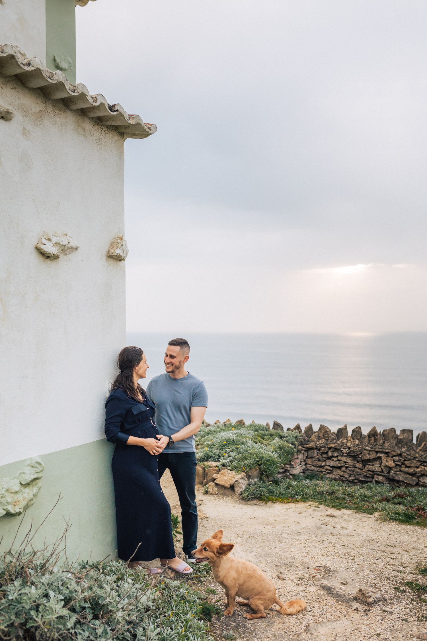 Maternity photoshoot at Azenhas do Mar with a mom-to-be surrounded by coastal cliffs and ocean views
