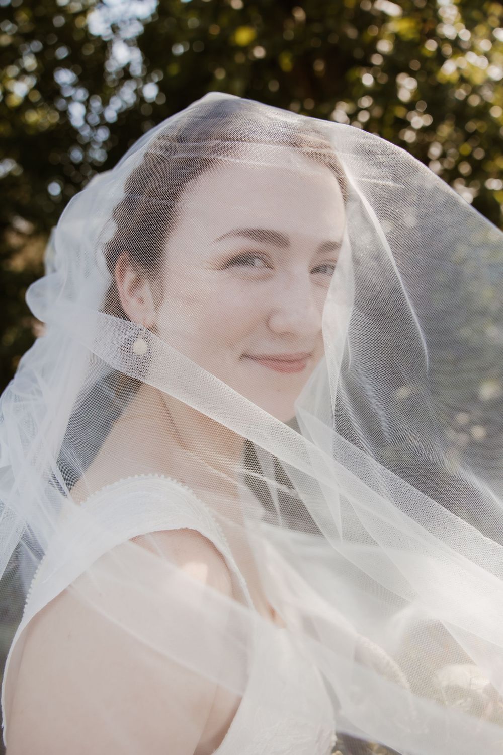Kansas City bride smiling during golden hour portraits at Meadowbrook Park, captured by Poemas Photo + Video.
