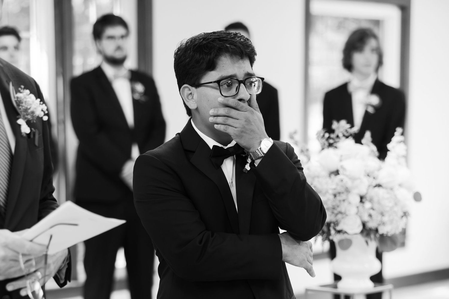 Groom wiping away tears during heartfelt vows at a Pensacola wedding