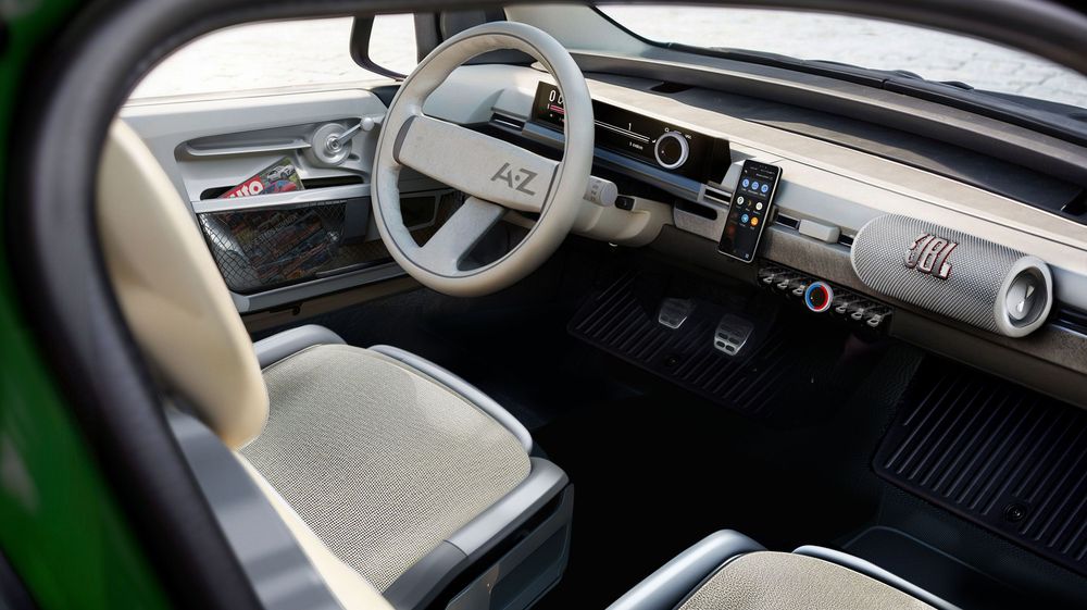 Modern car interior featuring a minimalist dashboard design with beige seats and digital displays.